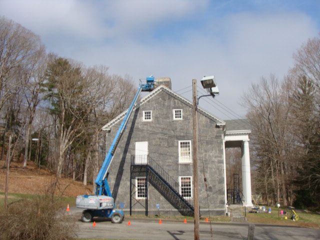 Boom lift at the stone gable of Haddam's old town hall