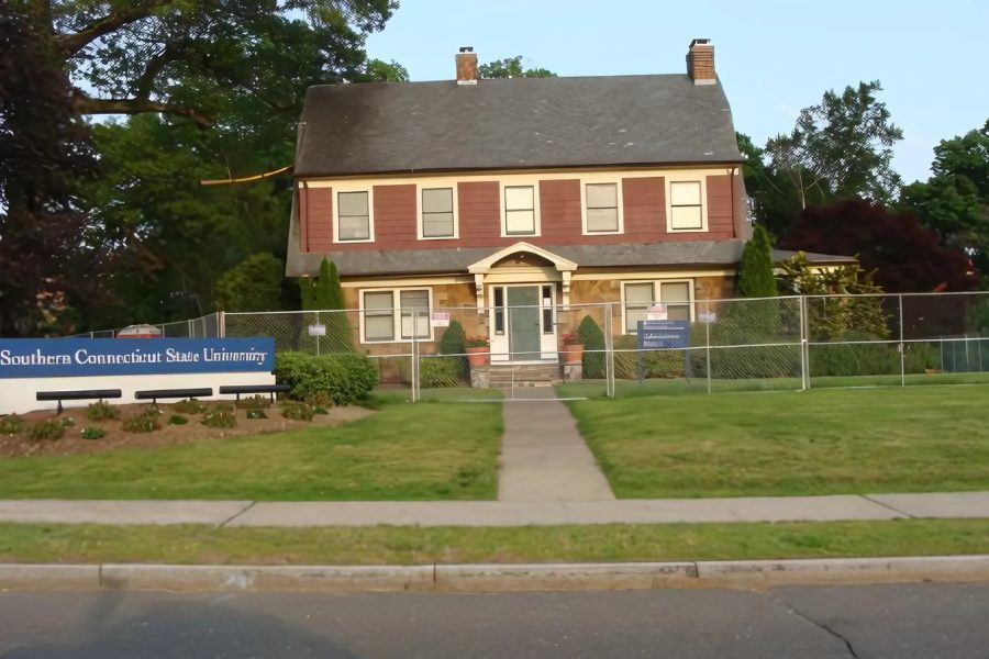 Southern Connecticut State University Admissions House, a brick colonial with SCSU signage on the lawn