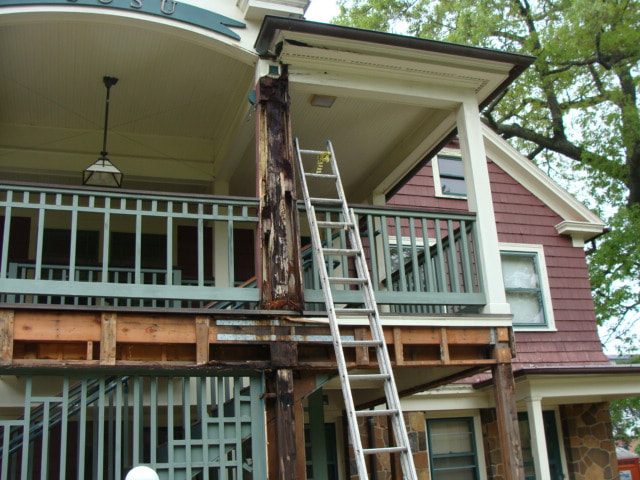 Deteriorated porch post and framing exposed before repair
